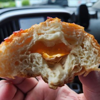 Mystic Market - a person holding a half eaten pastry - Specialty Food Near Me - Mystic, Connecticut Mystic Market - a person holding a half eaten pastry - Specialty Food Near Me - Mystic, Connecticut