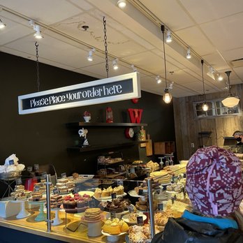 Purebread Whistler - a woman standing in front of a counter - Bakeries Near Me - Whistler, British Columbia