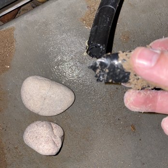 Alpha Innovations Construction & Remodeling - a hand holding a piece of cement and a rock - Masonry/Concrete Near Me - El Paso, Texas Alpha Innovations Construction & Remodeling - a hand holding a piece of cement and a rock - Masonry/Concrete Near Me - El Paso, Texas