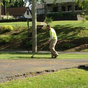 Top Seed Landscaping - a man mowing the grass - Landscaping Near Me Top Seed Landscaping - a man mowing the grass - Landscaping Near Me