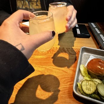 BJ's Restaurant & Brewhouse - two people toasting - Pizza Near Me - Lancaster, Pennsylvania