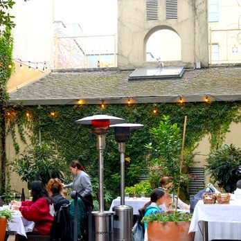 Laili Restaurant - Our Mediterranean-inspired patio features lush greenery, rustic stone accents, and cozy seating, creating a relaxing, sun-soaked atmosphere - Middle Eastern Near Me - Santa Cruz, California