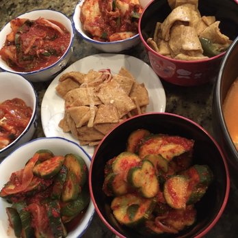BCD Tofu House - Side dishes of kimchi, fish cakes, pickled cucumbers, and marinated squid - Korean Near Me - Irvine, California