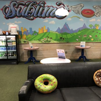 Sublime Doughnuts - Doughnut pillows on the couch in the dining area. - Donuts Near Me - Atlanta, Georgia