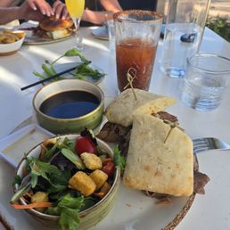 This is the Prime Rib Dip sandwich, with the house salad vinegarette dressing and Bloody Mary. One take away was dirty celery in my drink This is the Prime Rib Dip sandwich, with the house salad vinegarette dressing and Bloody Mary. One take away was dirty celery in my drink