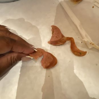 The Saucy crab - a person peeling a piece of food - Seafood Near Me - Tinley Park, Illinois