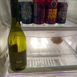 a bottle of wine in a refrigerator a bottle of wine in a refrigerator