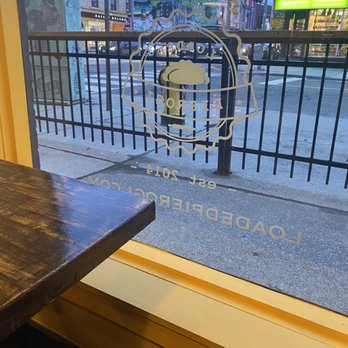 Loaded Pierogi - a view of a city street through a window - Bars Near Me - Toronto, Ontario