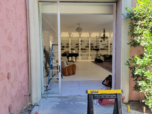 Sliding door roller replacement - Had to remove the pocket interlock to pull the sliding glass door out of each pocket. We cut back the stucco and shimmed the interlock when