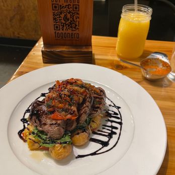 Fogonero Restaurant - Caracas Fillet Mignon with a passion fruit drink - Venezuelan Near Me - Pflugerville, Texas Fogonero Restaurant - Caracas Fillet Mignon with a passion fruit drink - Venezuelan Near Me - Pflugerville, Texas