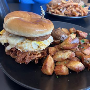Root & Press - R&P Riddler-Two eggs, sausage, cheddar, crispy potato pancake, and maple syrup - stacked on brioche with extra crispy home fries - Cafes Near Me - Worcester, Massachusetts