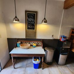 Hotel California - Full kitchen area, fruit bowl, breakfast hours sign