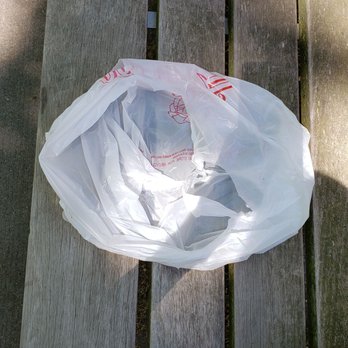 Thai Tom - The empty bag is showing that they forgot our forks/spoons and napkins with their terrible and unfair customer service. - Thai Near Me - Seattle, Washington