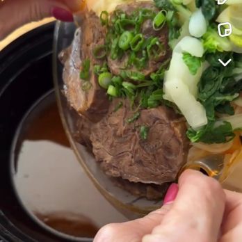 Flaming Ox - Spicy ox soup to go. Adding the ingredients to the hot soup. - Taiwanese Near Me - San Jose, California Flaming Ox - Spicy ox soup to go. Adding the ingredients to the hot soup. - Taiwanese Near Me - San Jose, California