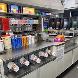 7-Eleven - Organized coffee station with variety of creamers