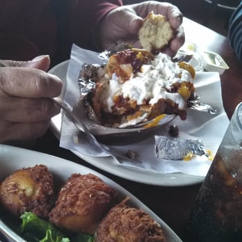 Yorktown Pub - Loaded potato and a side of hush puppies. - Pubs Near Me - Yorktown, Virginia Yorktown Pub - Loaded potato and a side of hush puppies. - Pubs Near Me - Yorktown, Virginia