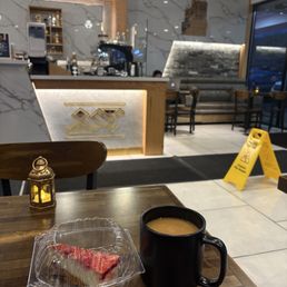 Sana'ani coffee and a slice of cheesecake they gave me for free Sana'ani coffee and a slice of cheesecake they gave me for free