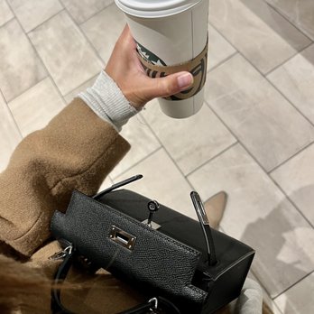 Starbucks - a woman holding a cup of coffee - Coffee & Tea Near Me - Los Angeles, California Starbucks - a woman holding a cup of coffee - Coffee & Tea Near Me - Los Angeles, California