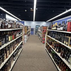 Whiskey Business - Brown liquor aisle with cold beer in back