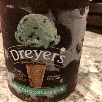 Shell - What we decided on - A tub of Dreyer's Mint Chocolate Chip ice cream is placed on a marble table, with a spoon nearby. The container features a scoop of mint ice cream with chocolate chips. - Gas Stations Near Me - Buckeye, Arizona