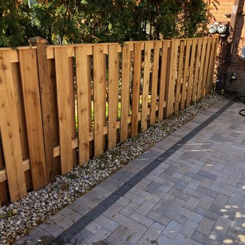A Garden Guy - a wooden fence in a backyard - Landscaping Near Me