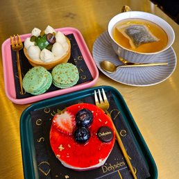 a plate of desserts and a cup of tea