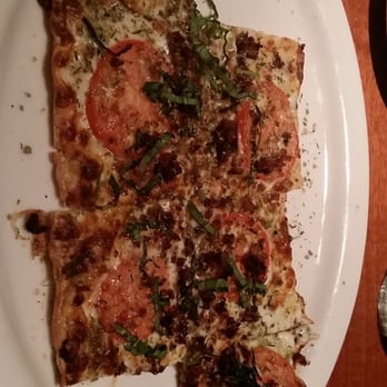 Charleston's - Best flat bread appetizer I have ever had. Delicious tomatoes and sausage on it with basil. - American Near Me - Fort Worth, Texas