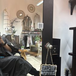 Innovations Salon & Boutique - Sitting in salon chair in front of mirror.