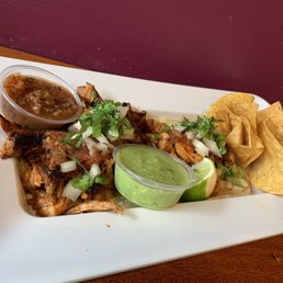 1 al pastor and 1 pollo taco, chips, and red and green salsa. 1 al pastor and 1 pollo taco, chips, and red and green salsa.