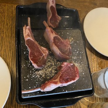 Burwell's Stone Fire Grill - Lamb lollipops on hot rock which you grilled yourself on the hot rock - New American Near Me - Charleston, South Carolina Burwell's Stone Fire Grill - Lamb lollipops on hot rock which you grilled yourself on the hot rock - New American Near Me - Charleston, South Carolina