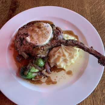 Maximilien - Cote de Proc 16oz pork tomahawk, garlic butter, demi-glacé, mash potatoes & brussle sprouts with caramelized onions and thick cut bacon ends - French Near Me - Seattle, Washington Maximilien - Cote de Proc 16oz pork tomahawk, garlic butter, demi-glacé, mash potatoes & brussle sprouts with caramelized onions and thick cut bacon ends - French Near Me - Seattle, Washington