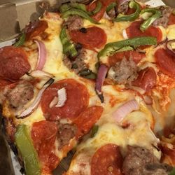 The Great American Pizza - Downtown Chicago pan, can see the cheese and pepperonis not cooked enough.