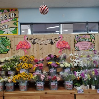 Trader Joe's - Flamingos above flower display. - Grocery Near Me - Coral Springs, Florida