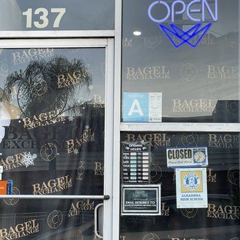 Bagel Exchange - Neon sign said open. But the sign next to the business hours said closed.  The business states it opens at 7am - Coffee & Tea Near Me - Alhambra, California