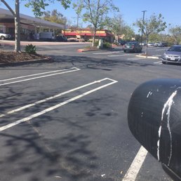 a parking lot with a parking meter in the foreground