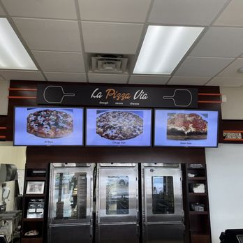 La Pizza Via - pizzas on display in a restaurant - Three digital screens show images of NY Style, Chicago Style, and Detroit Style pizzas at La Pizza Via. - Pizza Near Me - Fox River Grove, Illinois