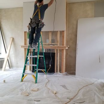 Rapid Drywall - One of my guys hanging some drywall after framing the fire mantel - Drywall Installation & Repair Near Me - Cedar Rapids, Iowa Rapid Drywall - One of my guys hanging some drywall after framing the fire mantel - Drywall Installation & Repair Near Me - Cedar Rapids, Iowa