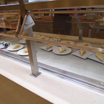 Tradewinds Buffet - Dessert plates with leftover cake slices are arranged behind a glass display at a buffet restaurant. - Buffets Near Me - Welch, Minnesota