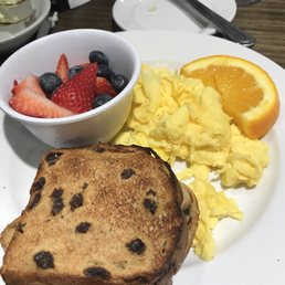 Two scrambled eggs with a side of berries and cinnamon toast Two scrambled eggs with a side of berries and cinnamon toast