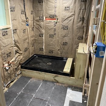 Handyman Adam - Basement bathroom project framed and insulated with flooring being laid out. - Handyman Near Me