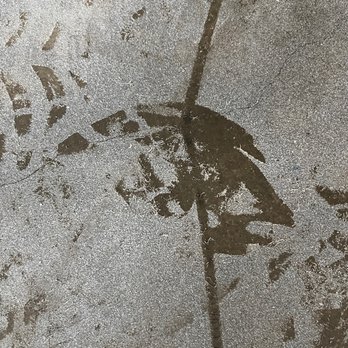Najera Environmental - Workers' bootprints in Fiberlock encapsulant as a loose powder because it would not stick to the oily solvent-soaked concrete slab floor. - Demolition Services Near Me - Santa Fe Springs, California