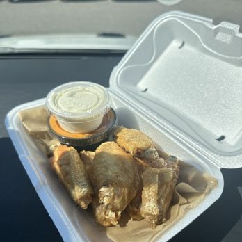Hooters - a takeout container with chicken wings and dipping sauce - Sports Bars Near Me - Lakeland, Florida