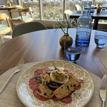 1906 Fine Dining - Beef carpaccio with a delicious black lime sauce, egg yolk and burrata (greens). Best dish by far! - New American Near Me - Kennett Square, Pennsylvania