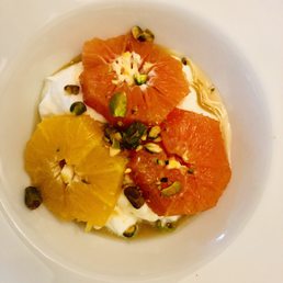 Breakfast starter: Greek yogurt, topped with orange slices, pistachios, and a drizzle of maple syrup