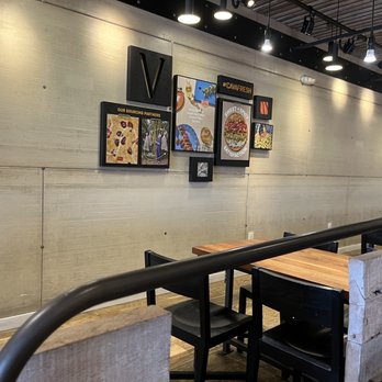 CAVA - the interior of a restaurant with tables and chairs - Mediterranean Near Me - Gaithersburg, Maryland