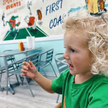Hot Dog Hut - Calvin's getting excited. They had a wooden high chair available. - Hot Dogs Near Me - Jacksonville Beach, Florida