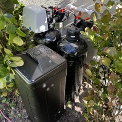 Water Co - City Water Softener & Carbon filter behind some hedges.
