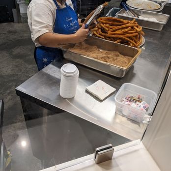 El Moro Churrería - Coating the churros in cinnamon sugar. Nov 2023. - Desserts Near Me - Costa Mesa, California El Moro Churrería - Coating the churros in cinnamon sugar. Nov 2023. - Desserts Near Me - Costa Mesa, California