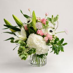 A whimsical bouquet from Bud Weismiller Florist in Las Vegas featuring lilies, hydrangea, carnations, roses, anemone, and lace flower.