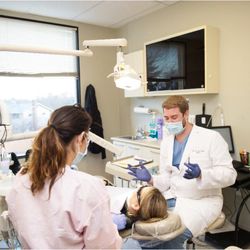 Richard G Wyne, DDS - Dentist speaking with a patient about their dental health.